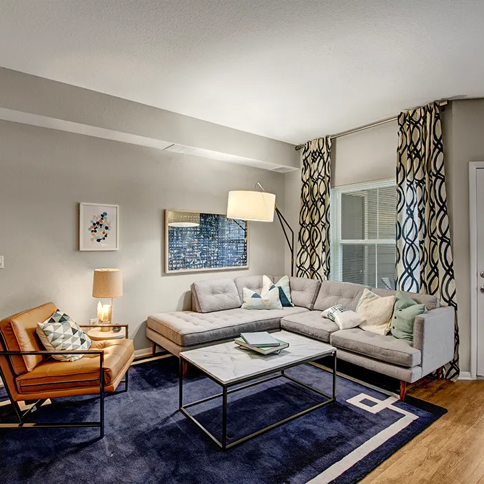 Living space featuring contemporary furniture, large windows, and decorative wall art