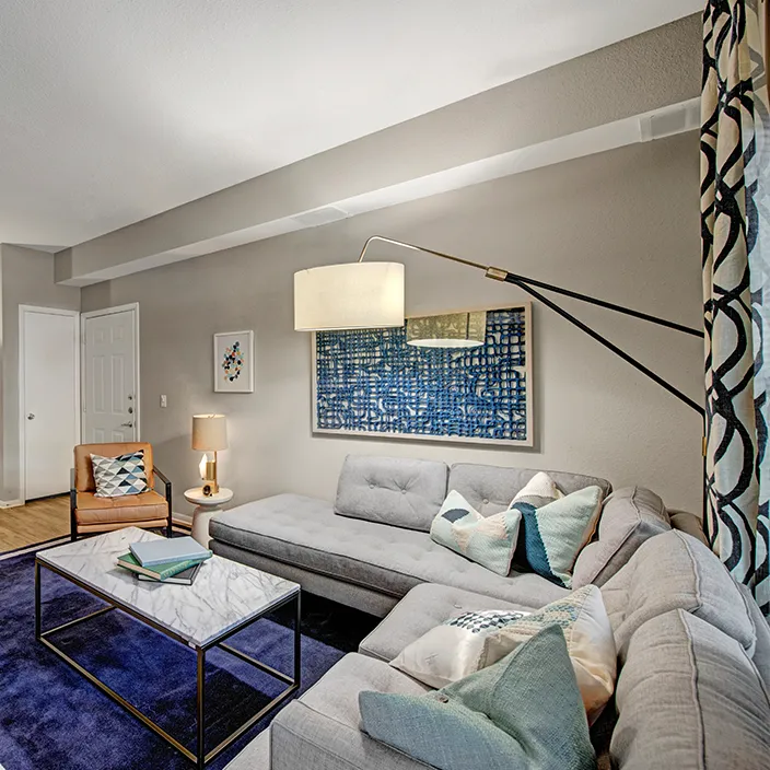 Luxurious living area with a sectional sofa, stylish accents, and a large lamp in the corner