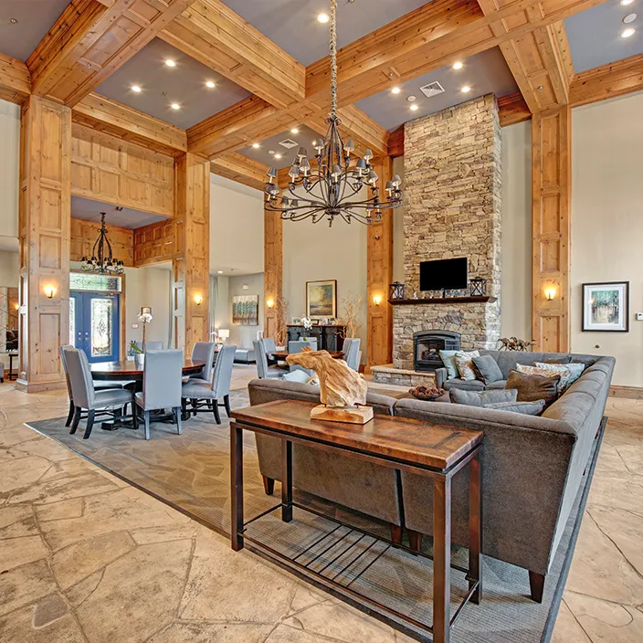 Elegant community lounge with wooden beams, stylish seating, and warm, inviting atmosphere